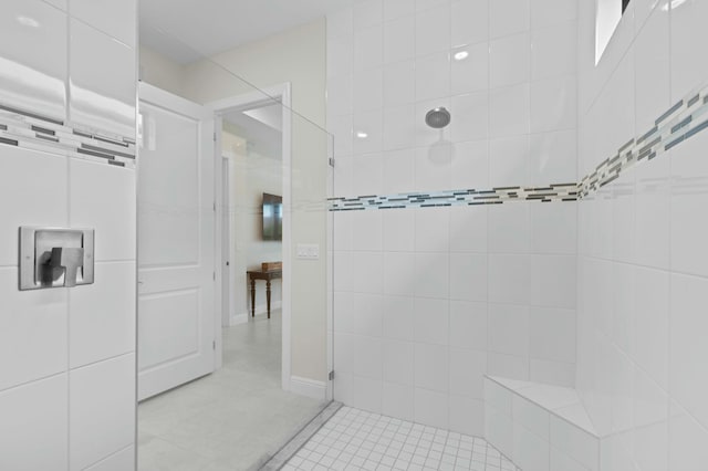 bathroom featuring tiled shower and tile patterned floors