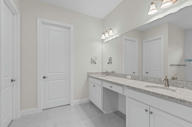 bathroom featuring tile patterned flooring and vanity