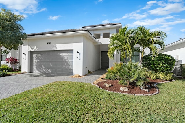 view of front of property with a front yard and a garage