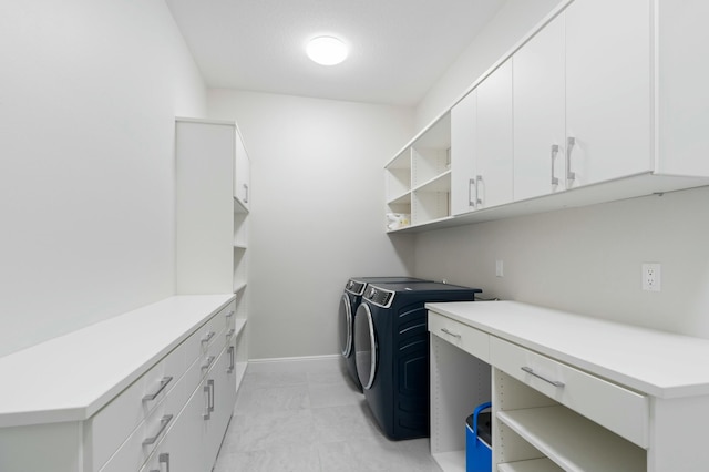 washroom featuring washer and clothes dryer and cabinets