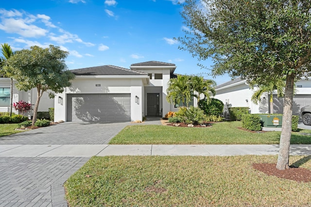 view of front of property featuring a garage and a front lawn