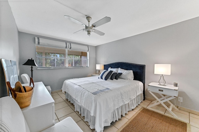 tiled bedroom featuring ceiling fan