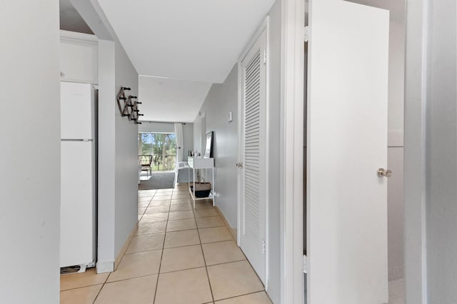 corridor featuring light tile patterned flooring