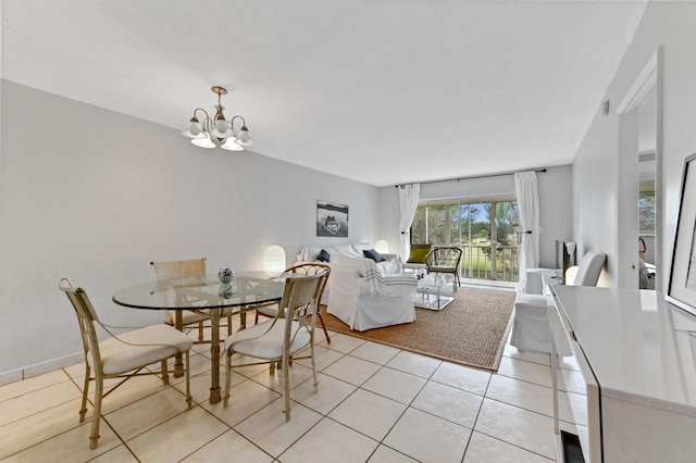 dining area featuring a notable chandelier and light tile patterned floors