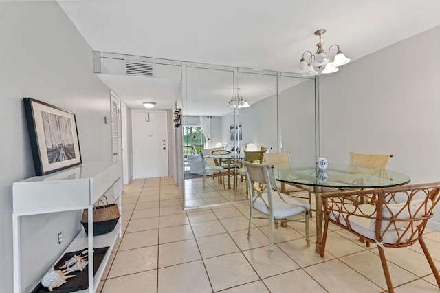 dining room with a notable chandelier and light tile patterned flooring