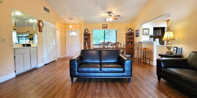 living room featuring hardwood / wood-style flooring, ceiling fan, and lofted ceiling