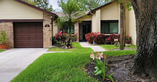 ranch-style house featuring a garage and a front yard