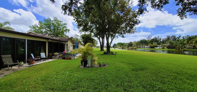 view of yard featuring a water view and a patio