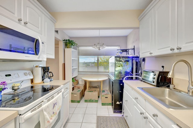 kitchen featuring white cabinetry, white appliances, sink, and an inviting chandelier