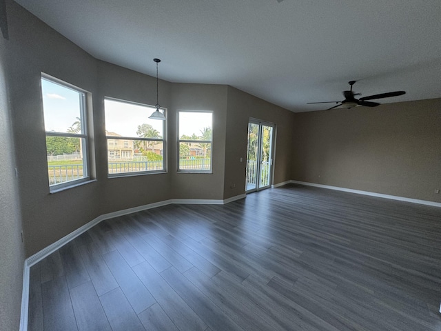 empty room with dark hardwood / wood-style floors and ceiling fan