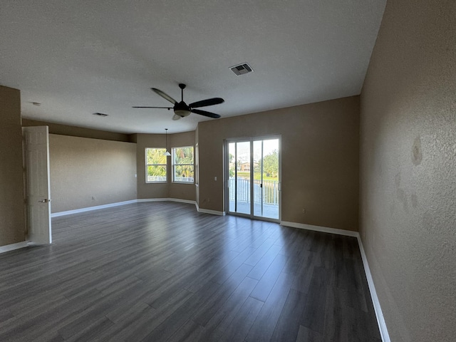 unfurnished room with a textured ceiling, dark hardwood / wood-style flooring, and ceiling fan