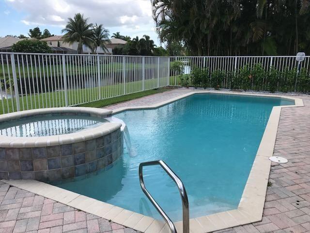 view of swimming pool with an in ground hot tub