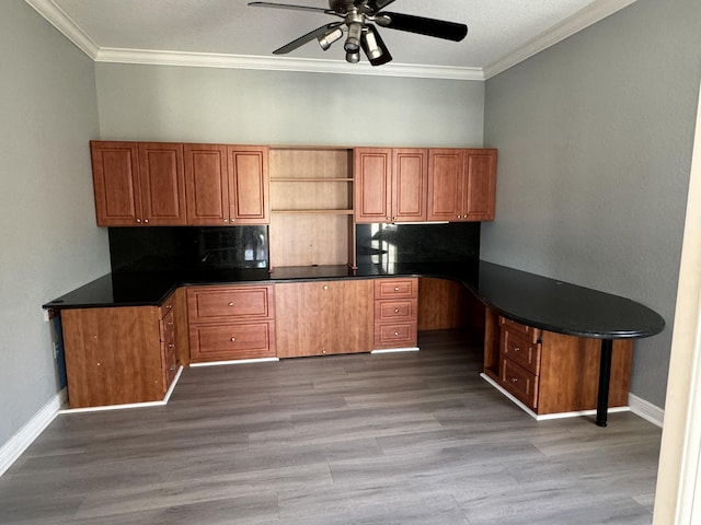 kitchen with ceiling fan, light wood-type flooring, ornamental molding, tasteful backsplash, and kitchen peninsula