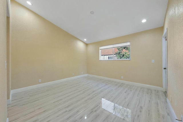 empty room with light hardwood / wood-style flooring