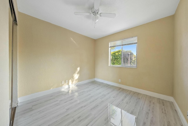 spare room with light hardwood / wood-style flooring and ceiling fan