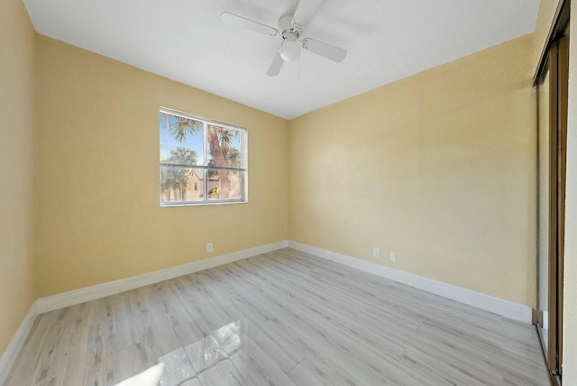 empty room with ceiling fan and light wood-type flooring