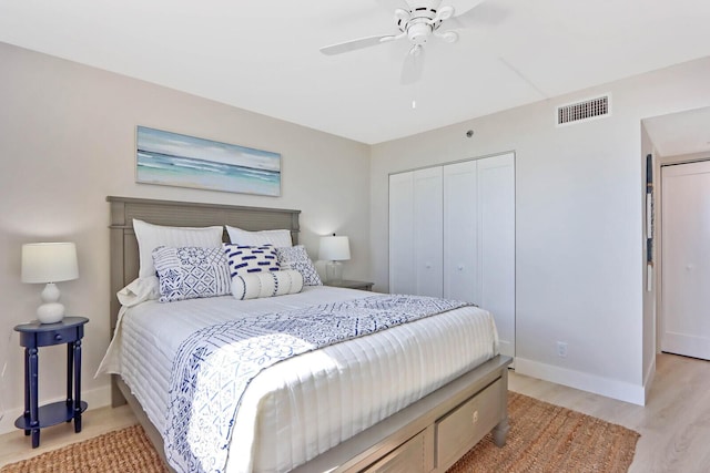 bedroom with ceiling fan, light hardwood / wood-style floors, and a closet