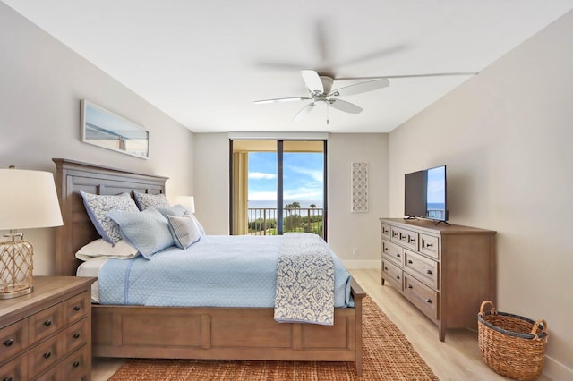 bedroom featuring access to exterior, light hardwood / wood-style flooring, and ceiling fan