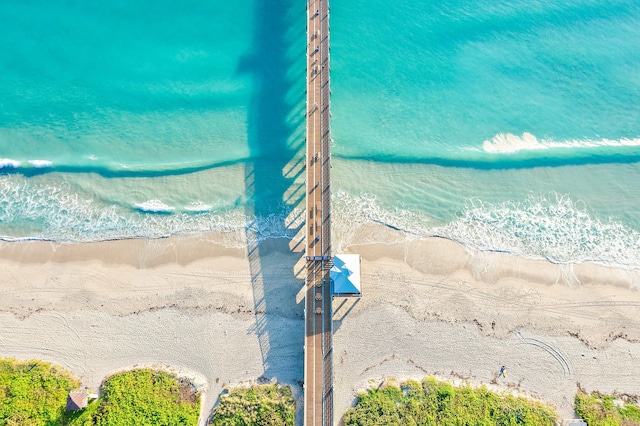 birds eye view of property featuring a beach view and a water view