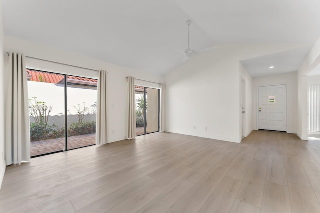 spare room featuring ceiling fan, light hardwood / wood-style floors, and lofted ceiling