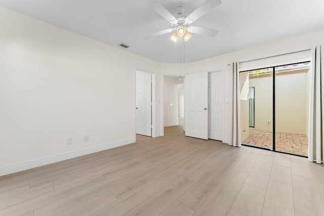 spare room featuring ceiling fan and light wood-type flooring