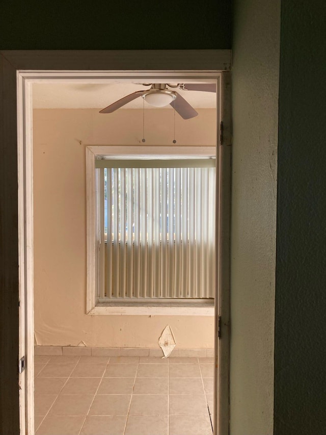 interior space with ceiling fan