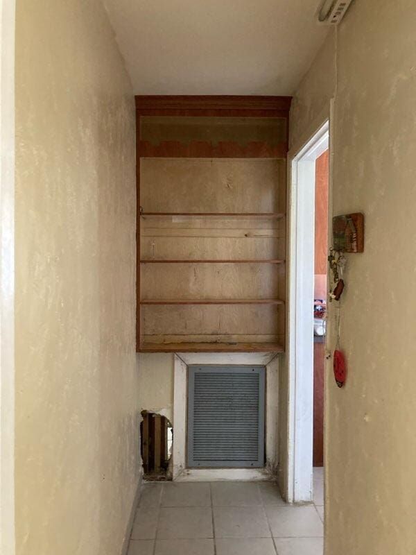 hallway featuring light tile patterned floors