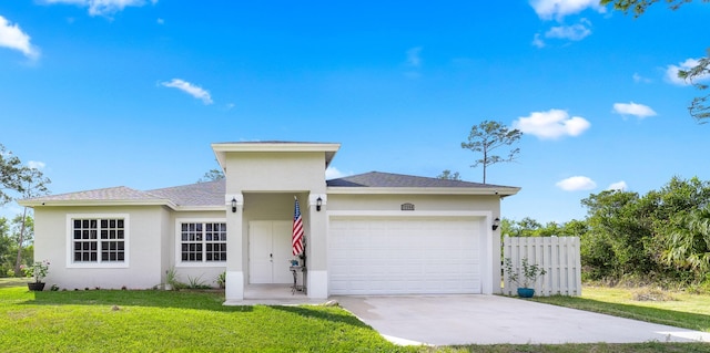 view of front of property with a front yard and a garage