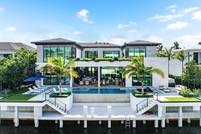 back of house with outdoor lounge area and a patio