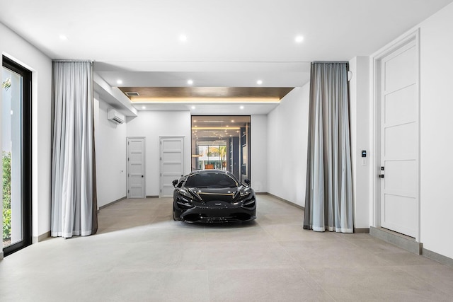 garage featuring a wall mounted air conditioner