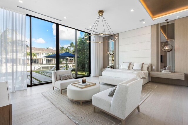 bedroom with access to exterior, light wood-type flooring, expansive windows, and a notable chandelier