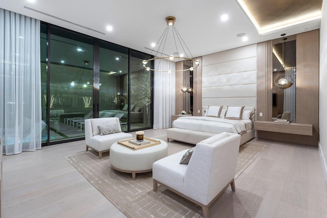 bedroom with an inviting chandelier, access to exterior, hardwood / wood-style flooring, and expansive windows