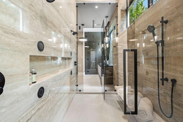 bathroom featuring tile patterned flooring and a shower with door