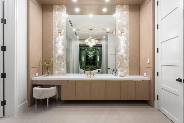 bathroom featuring a chandelier, vanity, and tile patterned floors