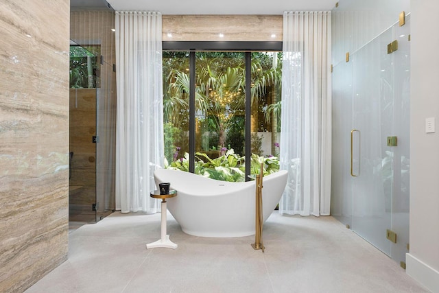 bathroom featuring shower with separate bathtub