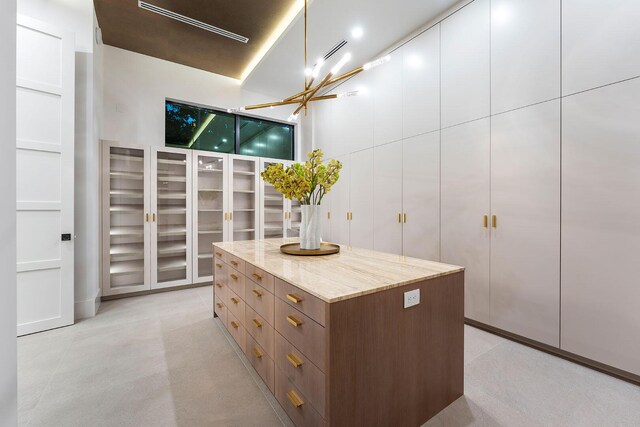 walk in closet featuring a chandelier