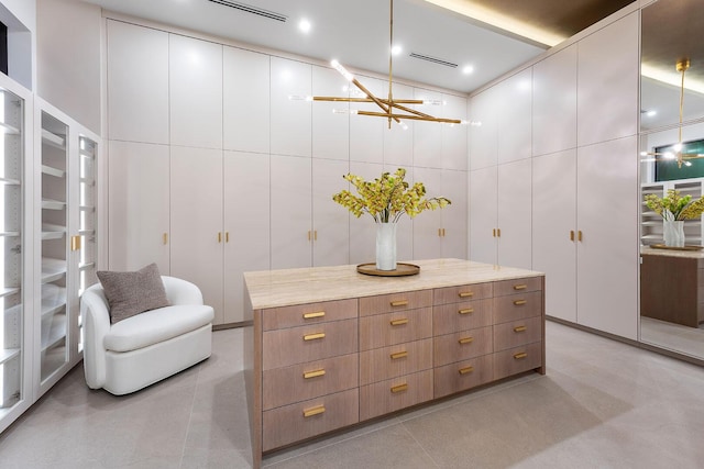 walk in closet featuring a chandelier