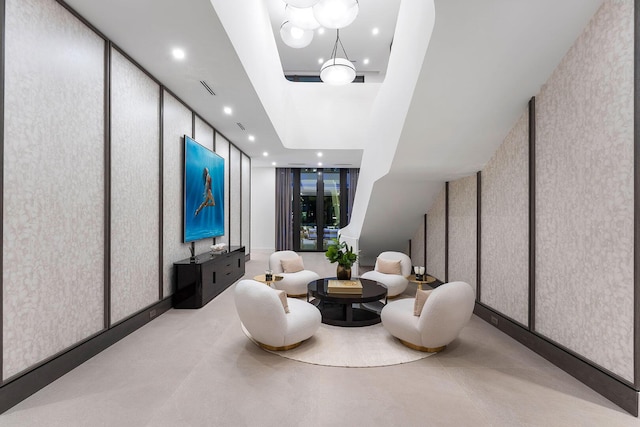 sitting room featuring a notable chandelier and floor to ceiling windows