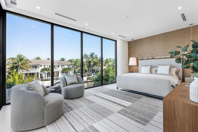 bedroom featuring multiple windows and floor to ceiling windows