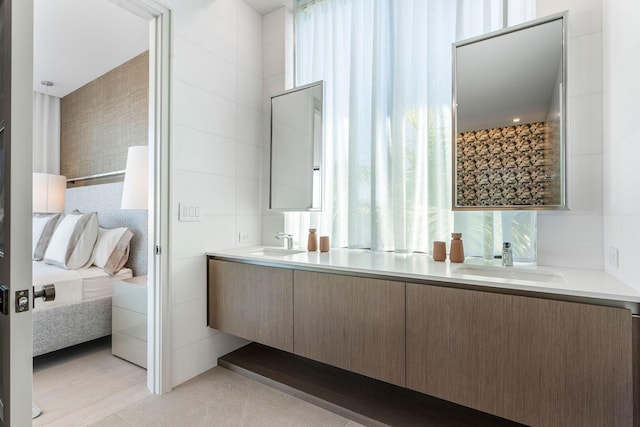 bathroom with vanity and tile walls