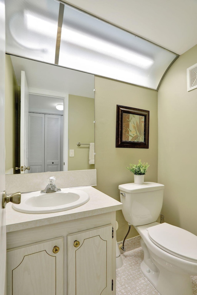 bathroom featuring tile patterned floors, vanity, and toilet