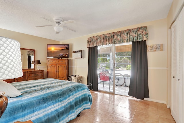 bedroom with ceiling fan, access to exterior, a textured ceiling, light tile patterned flooring, and a closet