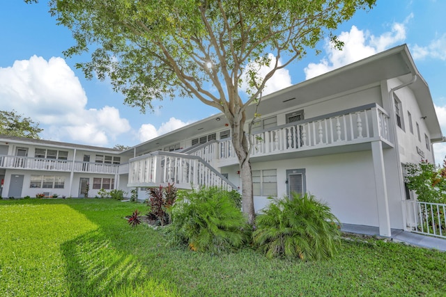 rear view of property with a lawn