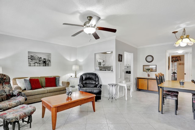 living room featuring ceiling fan, ornamental molding, a textured ceiling, and light tile patterned floors