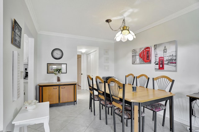 tiled dining area with an inviting chandelier and ornamental molding