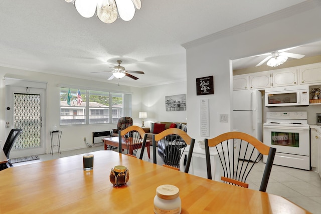 tiled dining space with crown molding, ceiling fan, and a textured ceiling