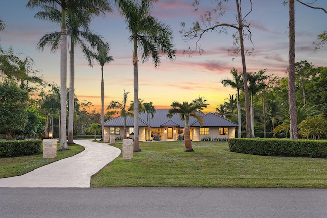 ranch-style home with a lawn