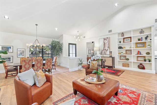 living room featuring hardwood / wood-style floors, a notable chandelier, and high vaulted ceiling