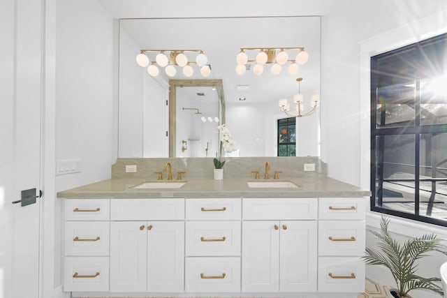 bathroom featuring vanity and a chandelier