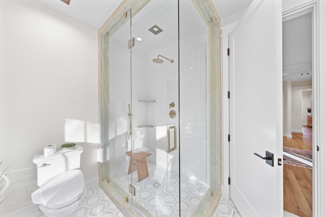 bathroom with tile patterned flooring, an enclosed shower, and toilet